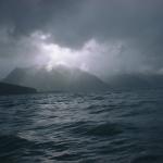 Sunshine peaks through the clouds at Seward