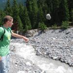 Joe tries to start a rock slide into the river