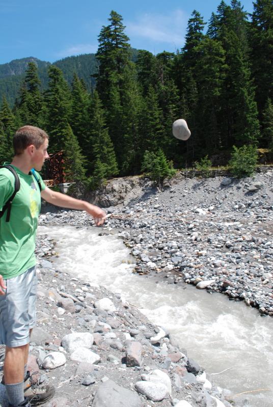 Joe tries to start a rock slide into the river