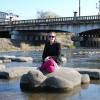 Katie resting on a turtle in the river